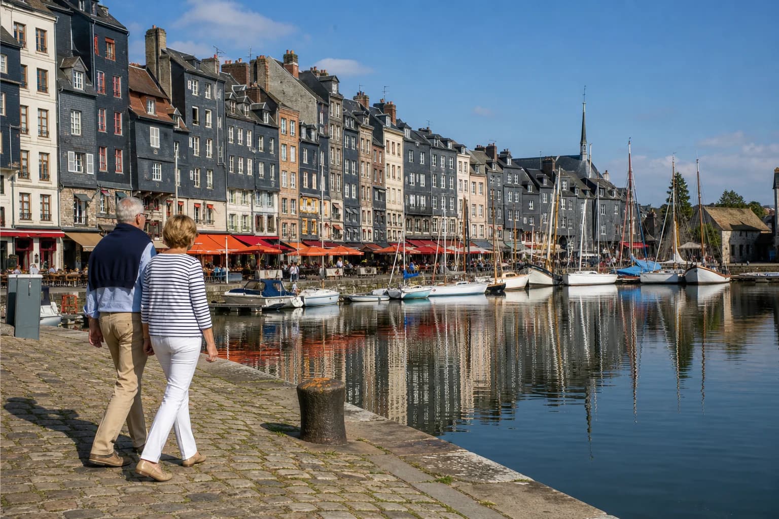 Retired cruise travellers walking beside the Vieux Bassin in Honfleur on a sunny morning